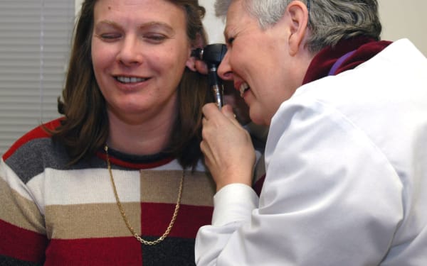 Woman gently touching her ear