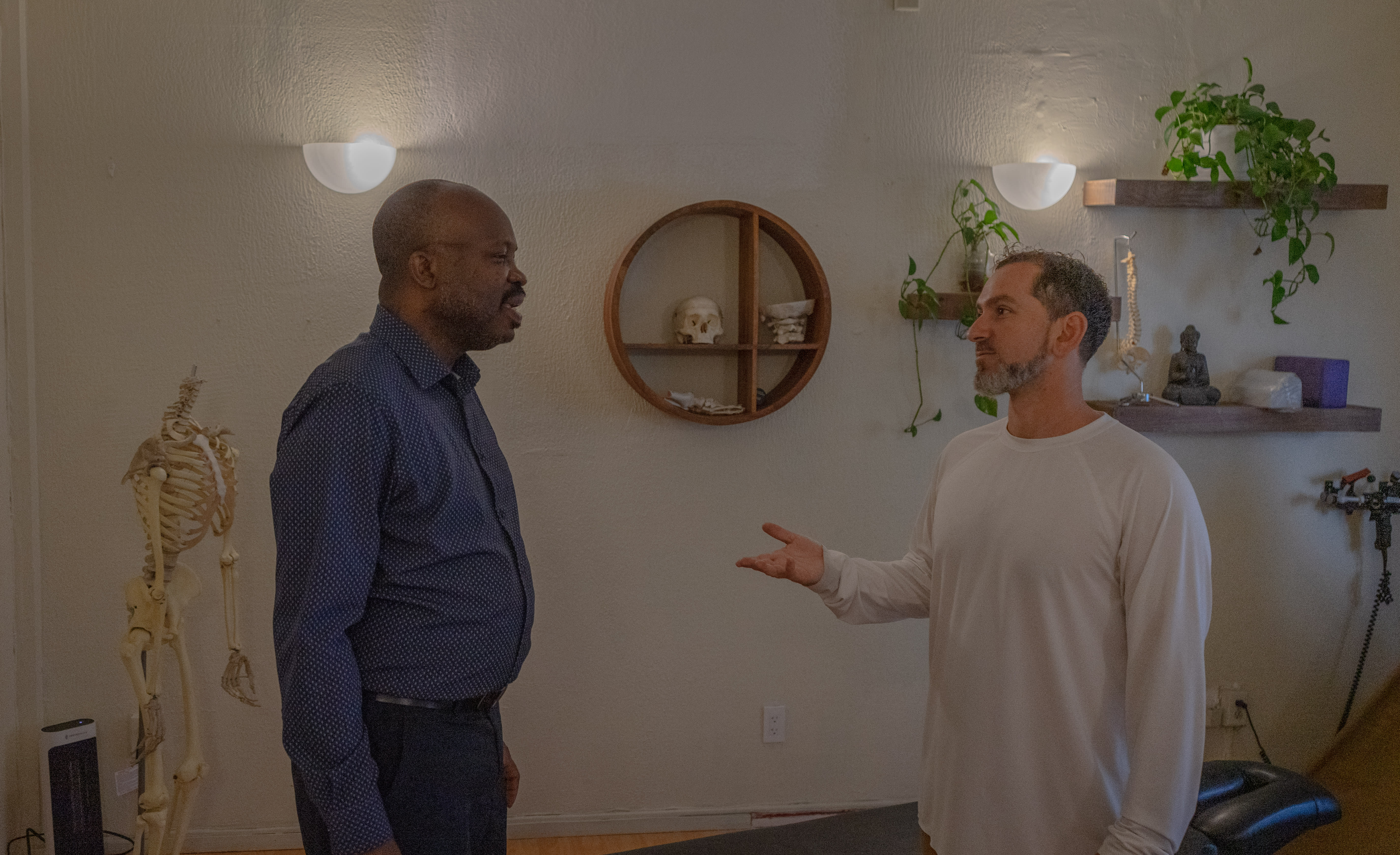 Dr. Ben Glass consulting with a patient during chiropractic visit at The Shift Chiropractic in Oakland