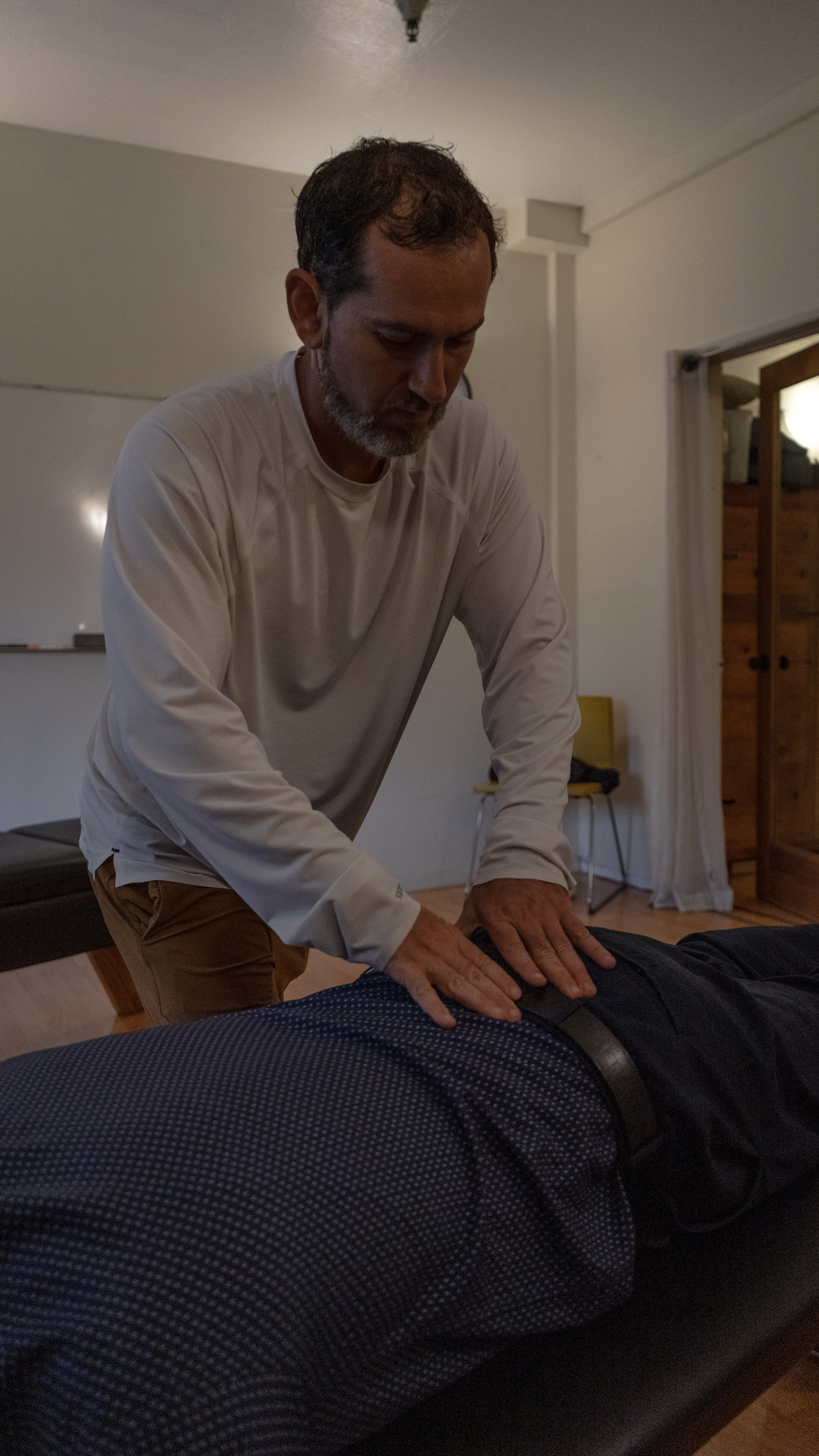 Dr. Ben Glass performing a precise manual chiropractic adjustment for back pain relief in Oakland