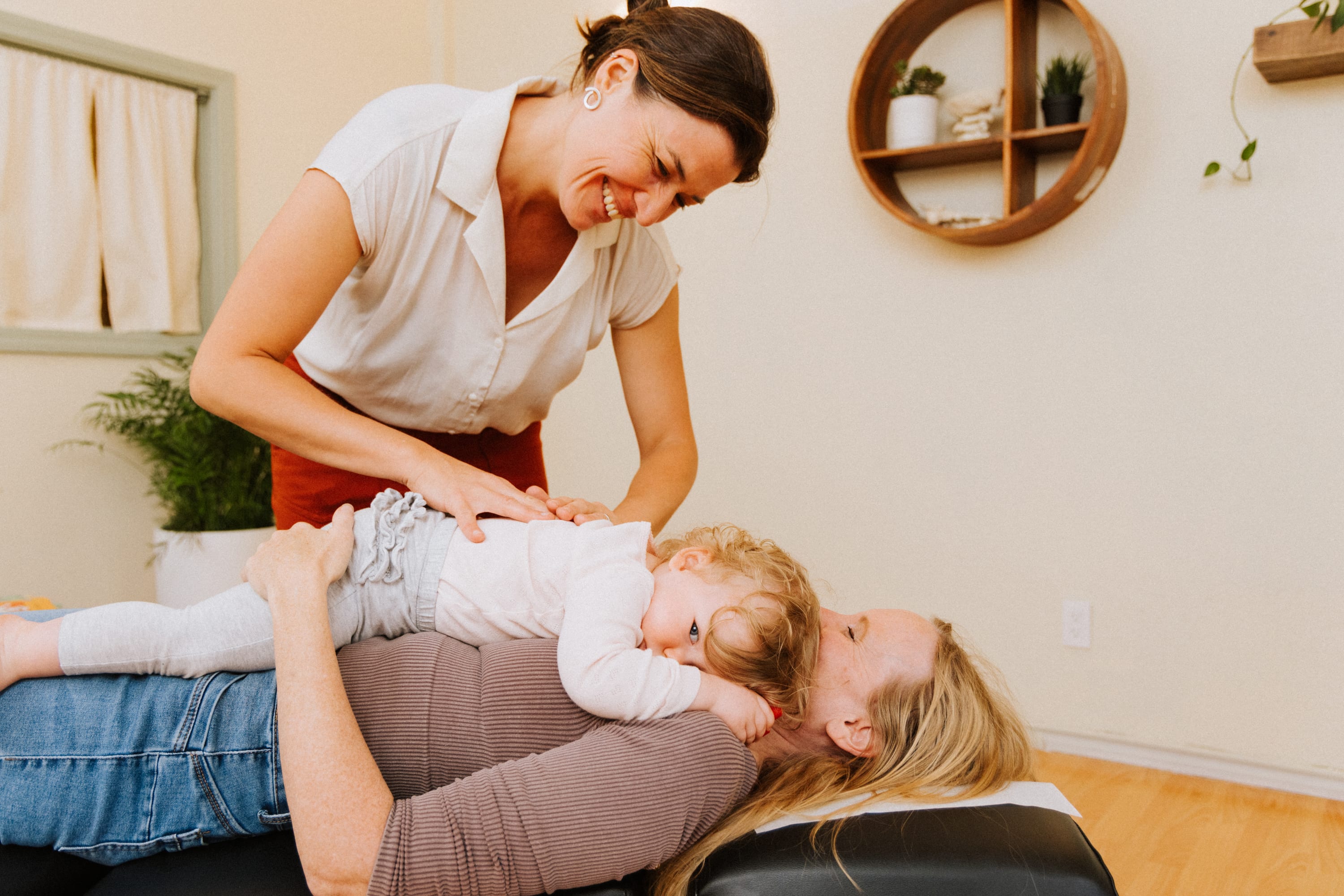 Chiropractor gently adjusting child during pediatric care at The Shift Chiropractic in Oakland