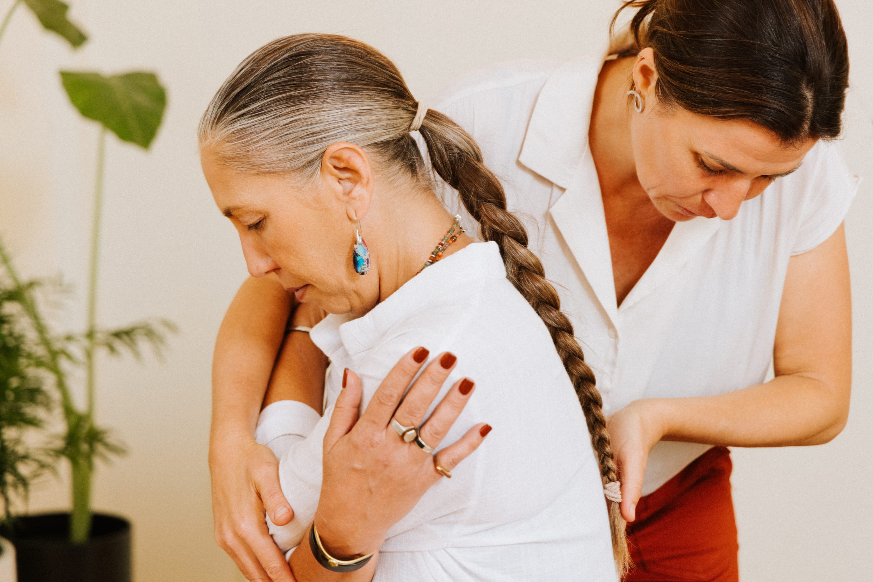 Chiropractor examining patient's back for back pain treatment at The Shift Chiropractic in Oakland