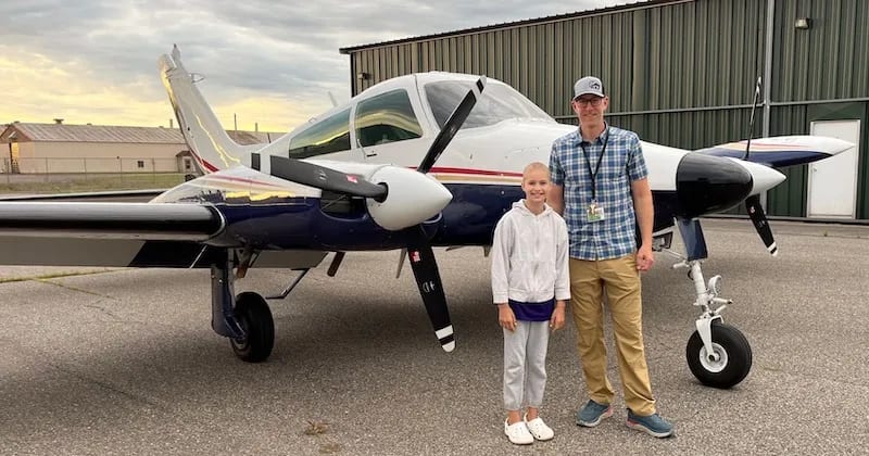 northwoods air lifeline pilot standing in front of plane with youth guest