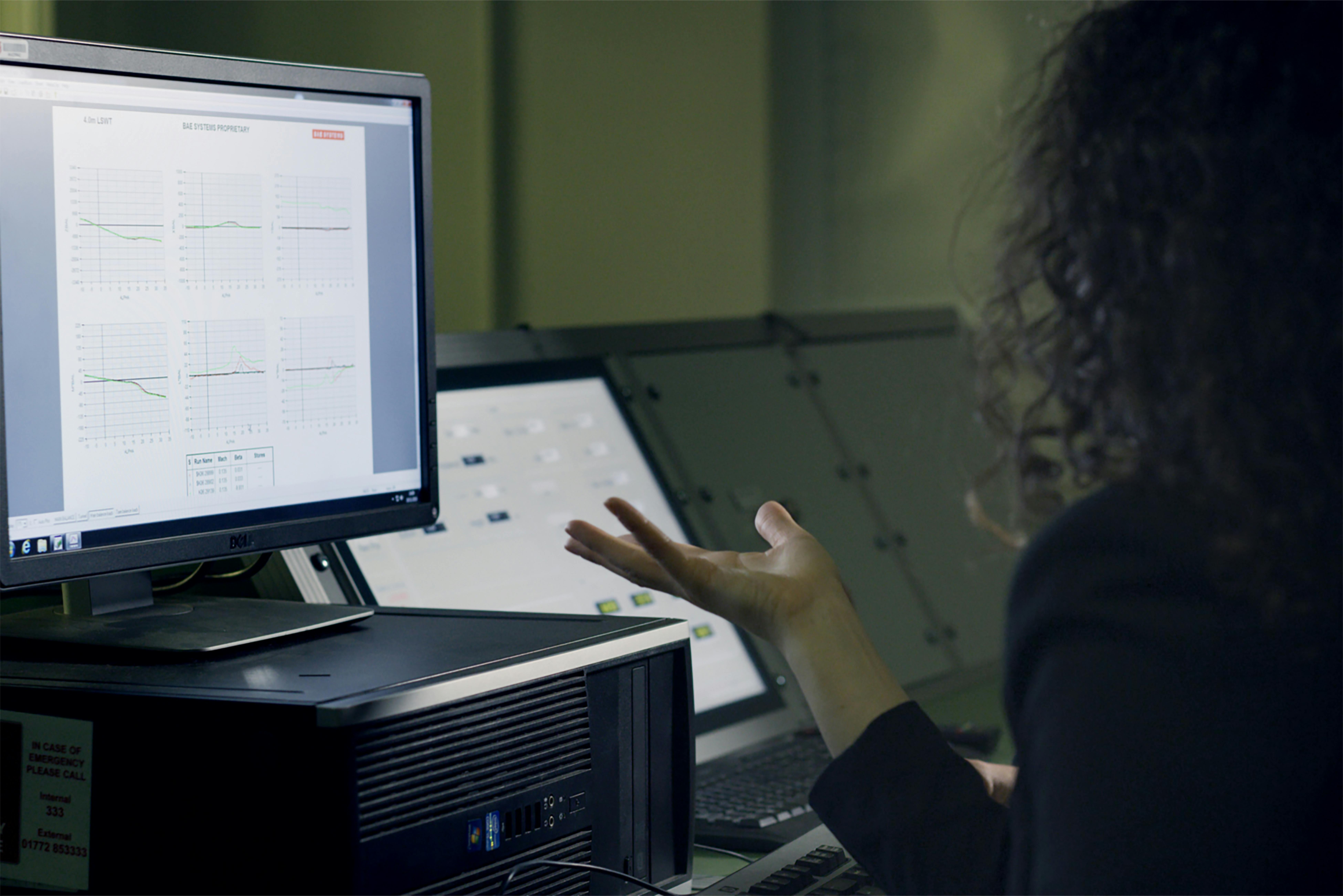Researcher at a computer screen showing both a graphical abstract and visual abstract of the same study side by side, demonstrating how the same research can be presented in differ