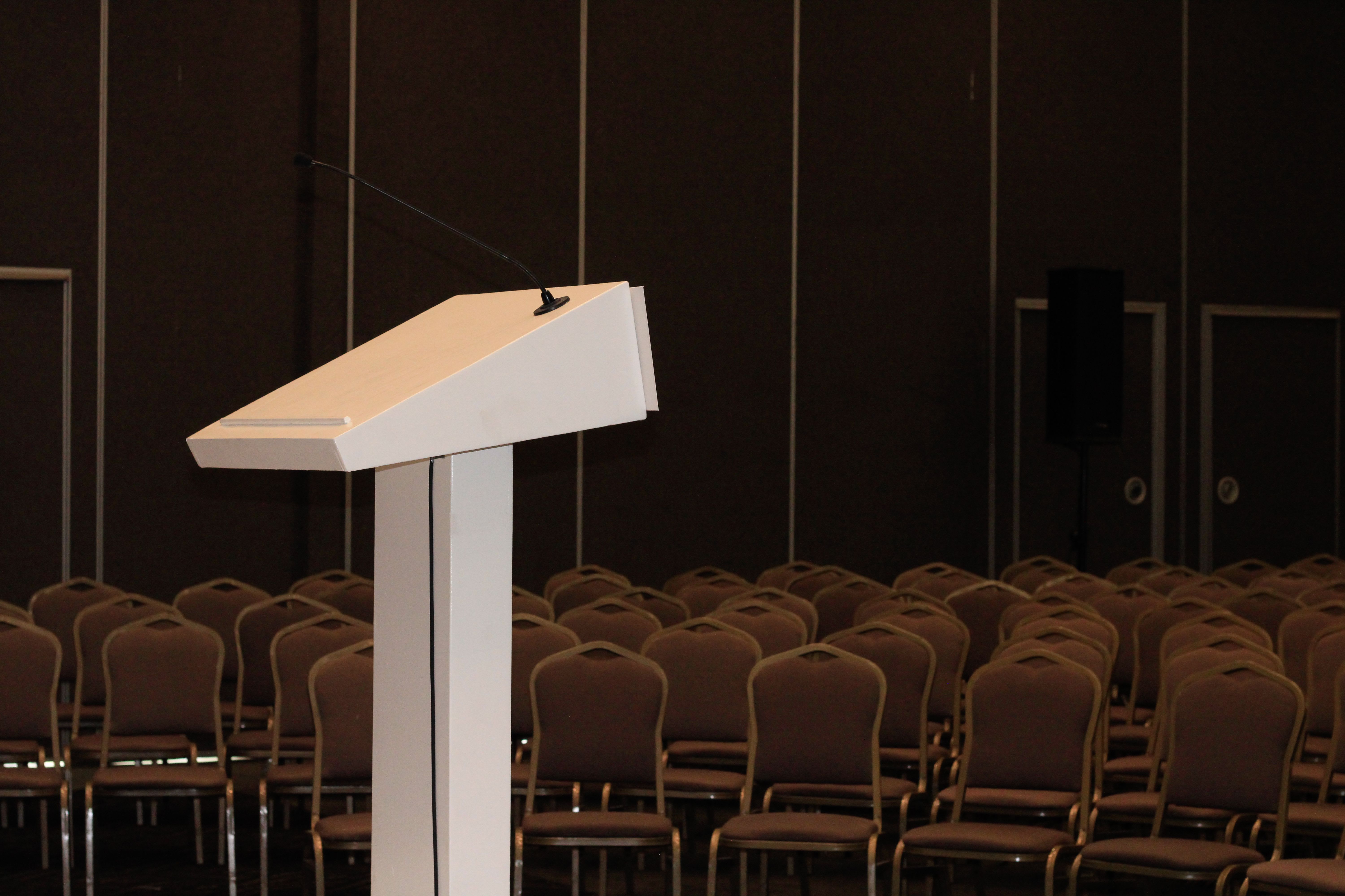 Different conference venue setups showing mounting systems for both landscape and portrait poster orientations