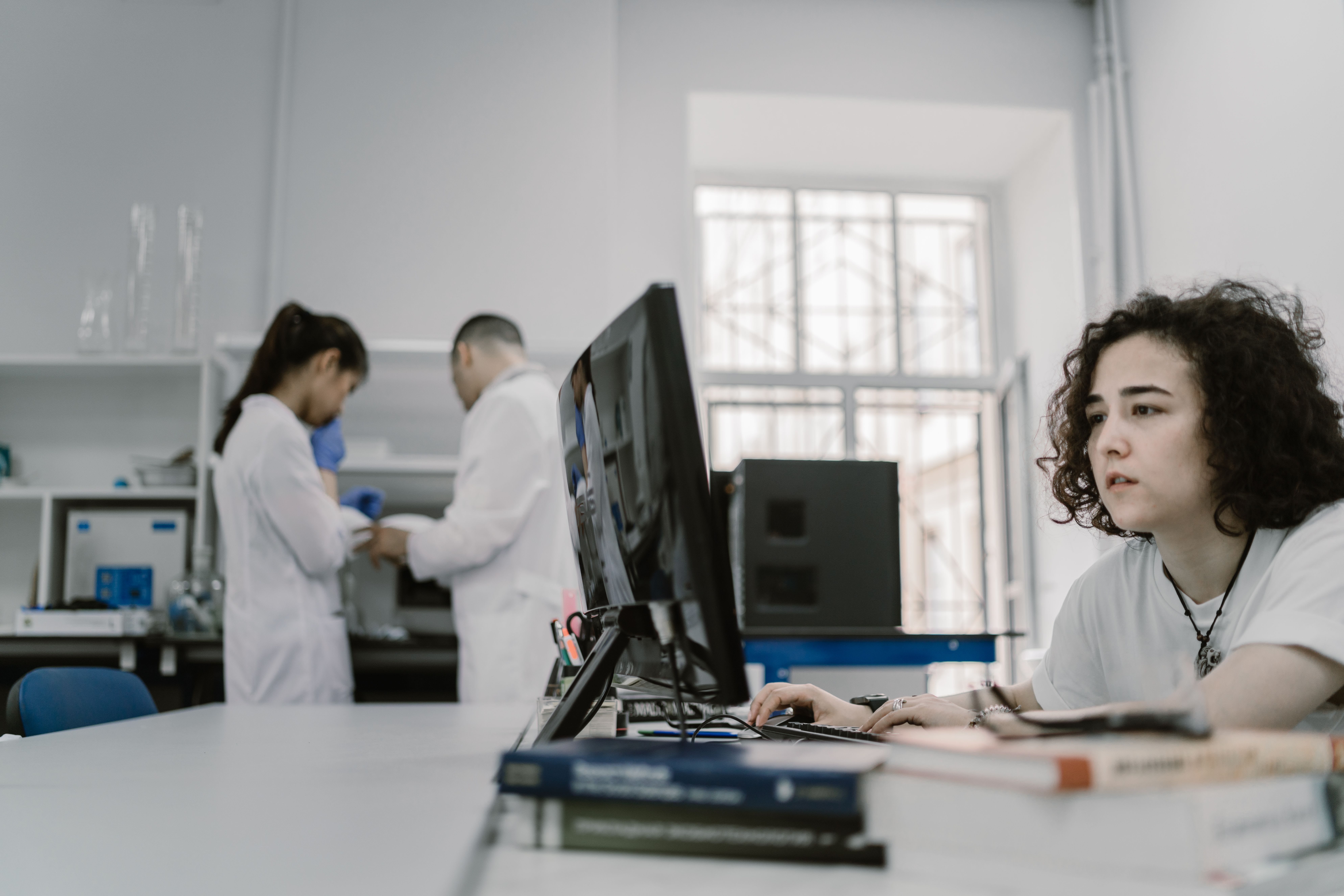 Researcher reviewing scientific figures on computer screen with copyright warning symbols highlighting problematic third party content