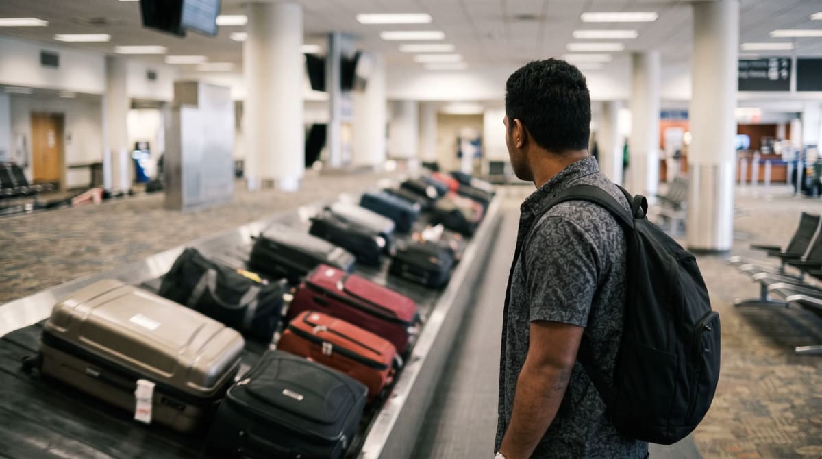 Traveler watching a baggage belt at an uncrowded claim area
