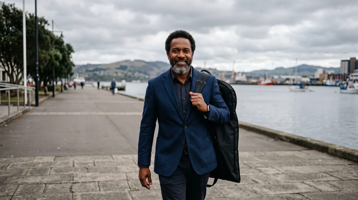 Traveler walking toward the camera on a waterfront promenade