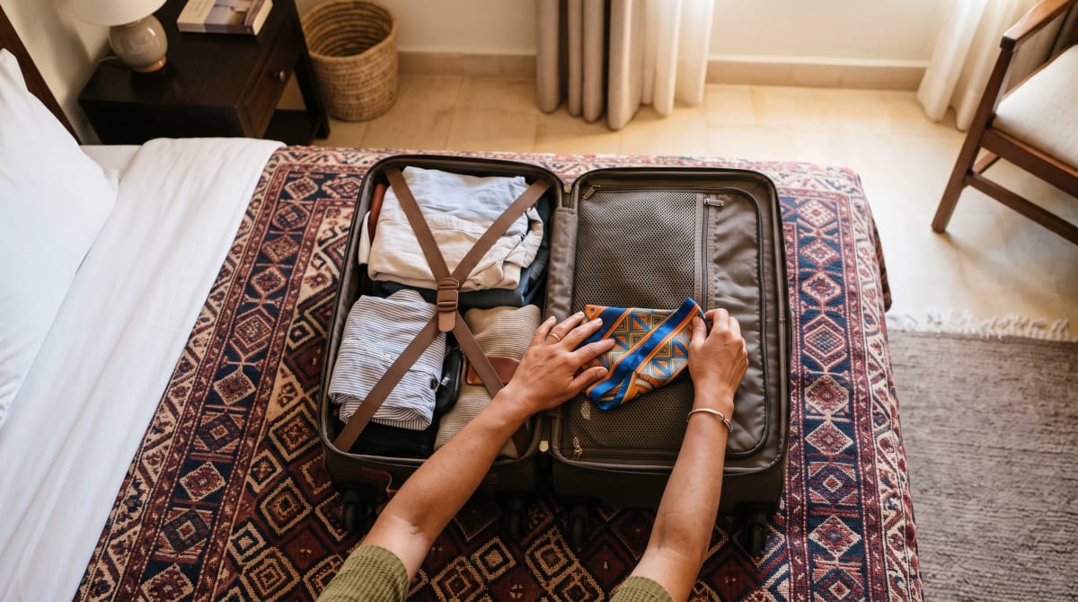 Overhead view of packing a suitcase on a Marrakech hotel bed