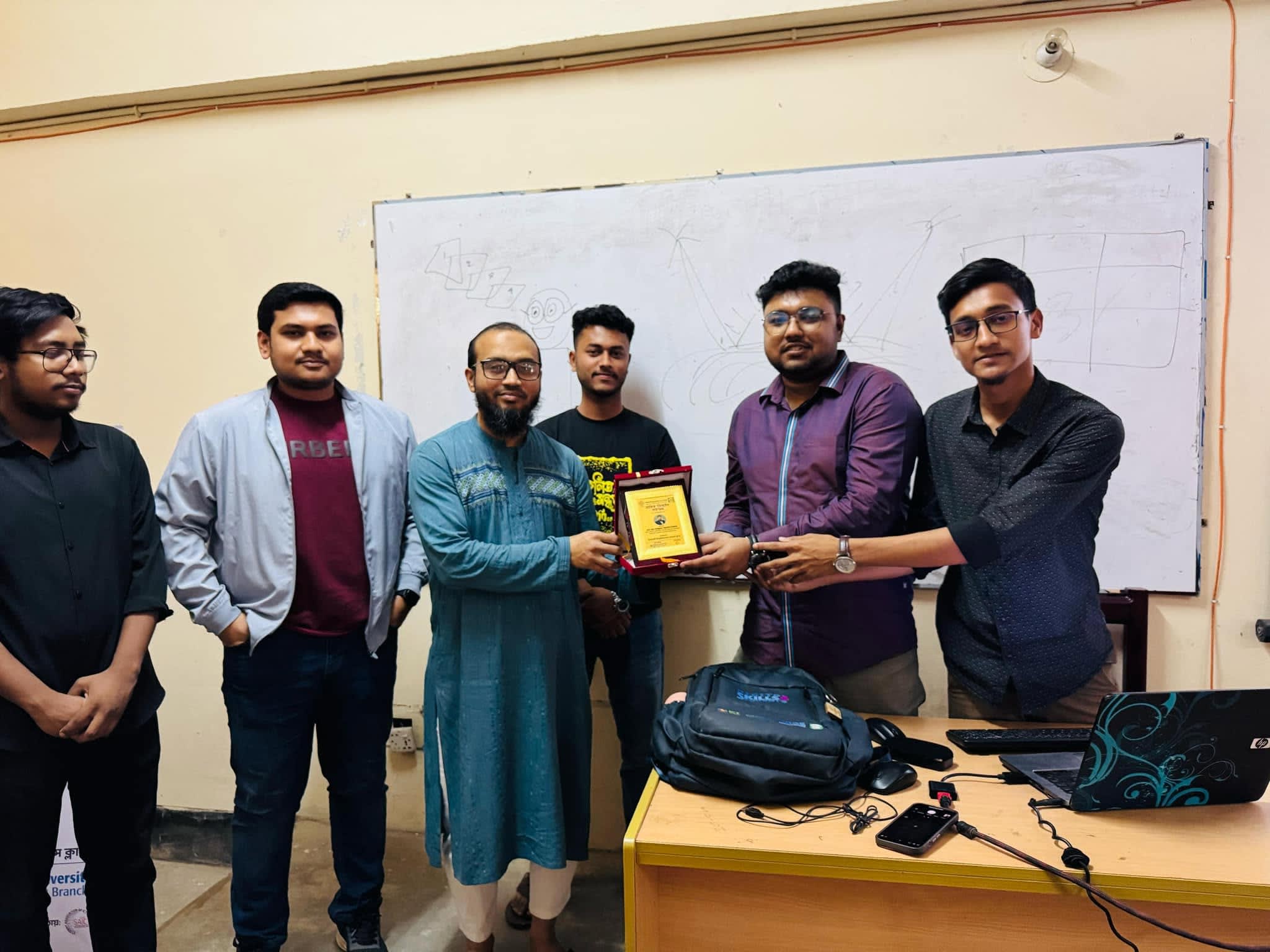 Receiving Crest as a Trainer at IUSC Graphic Design Workshop