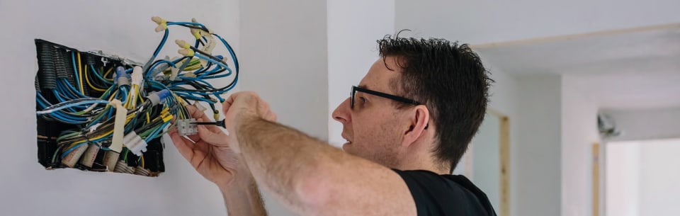 Electrician working on the wiring of a house