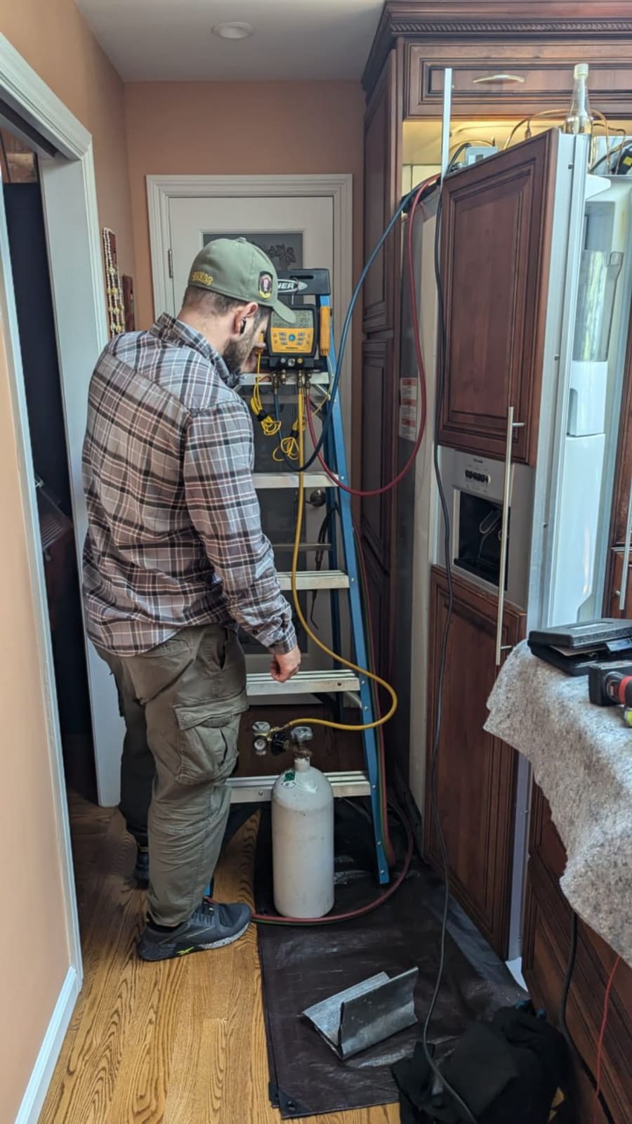 Technician at refrigerator repair work