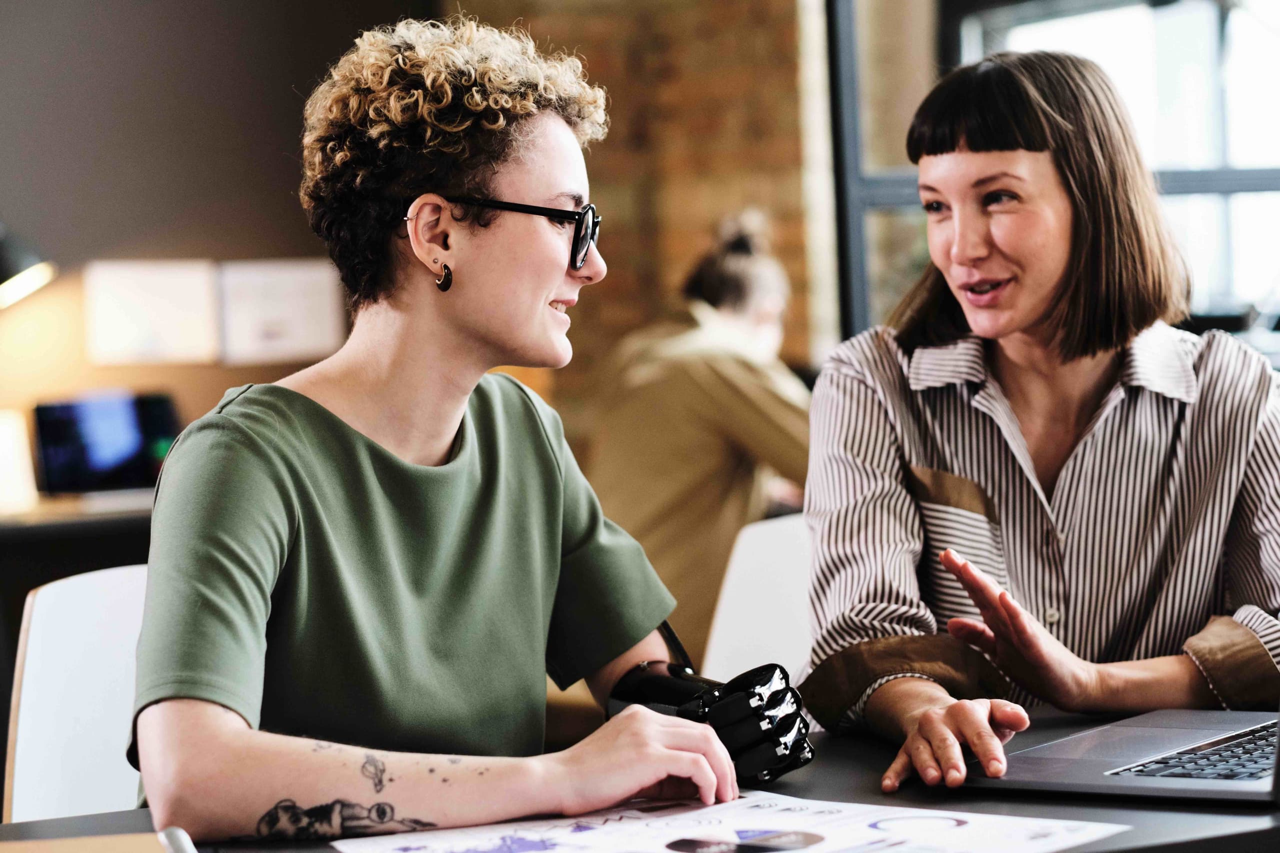 Consulting services MovingMood. Two woman having a business meeting at the office.