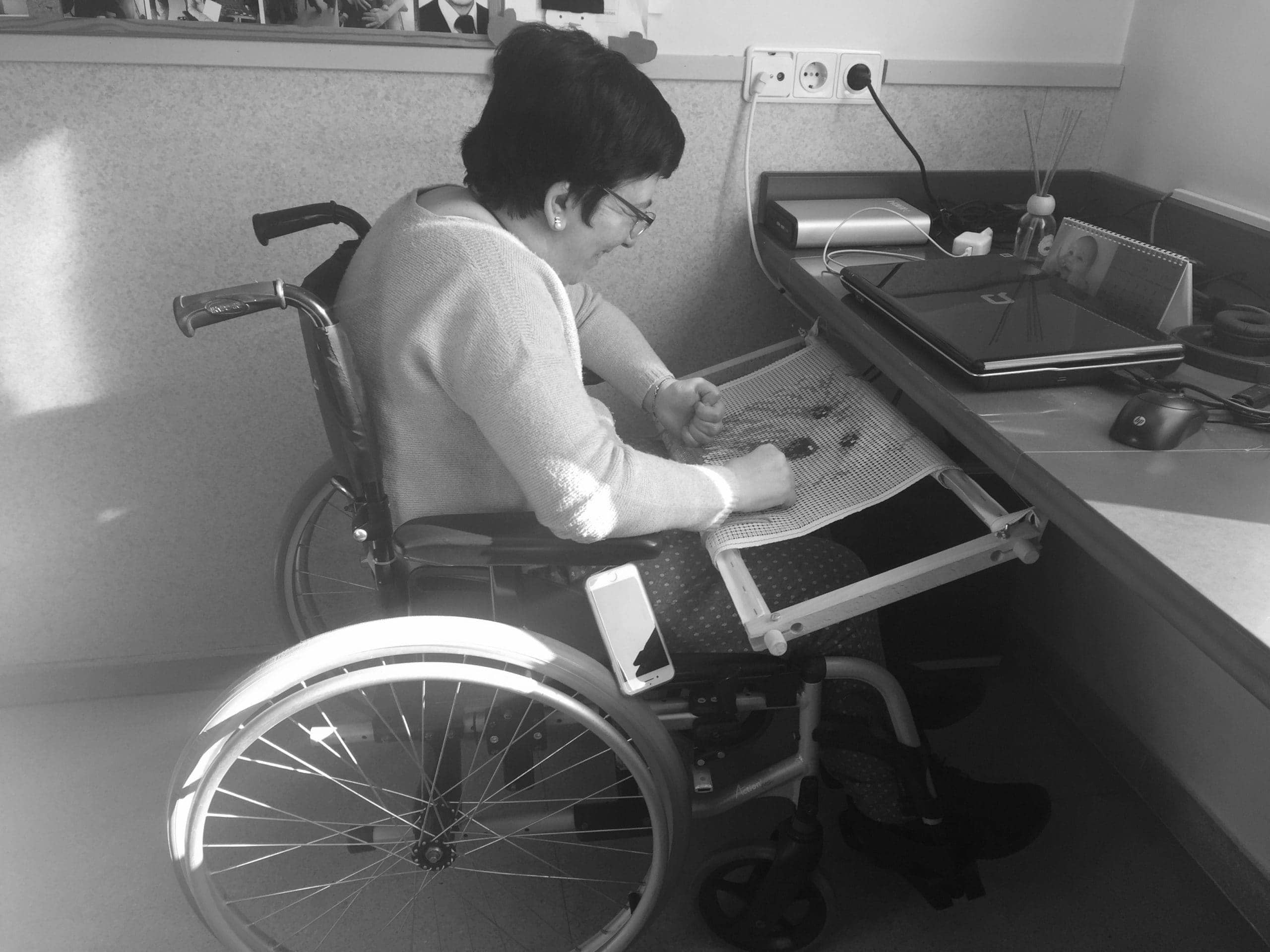 Inclusive fashion research. Image of a woman in her wheelchair embroidering.