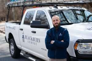 Chimney technician in front of truck