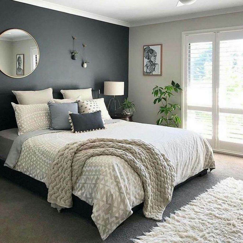 Bedroom with large window and wooden floors