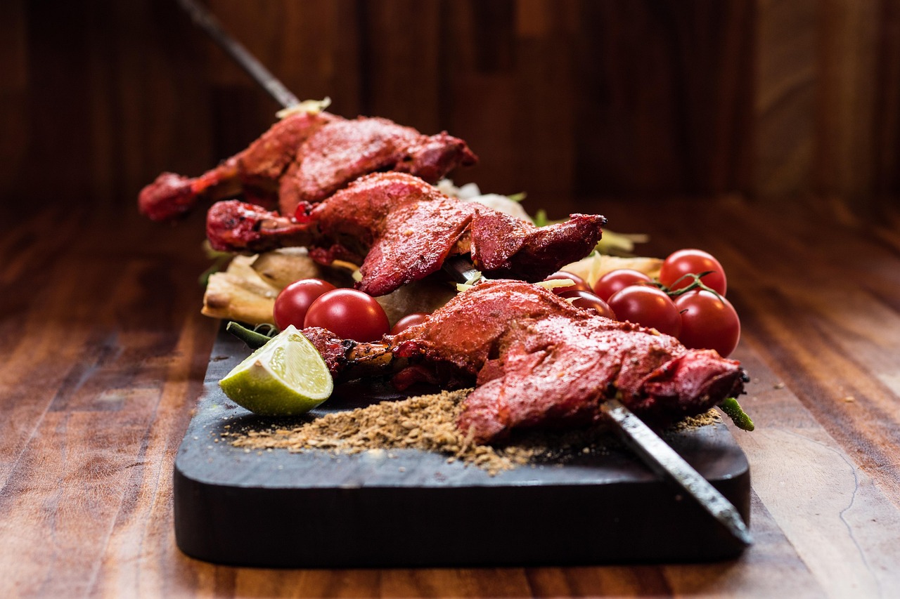 Tandoori chicken platter with grilled skewers and garnish