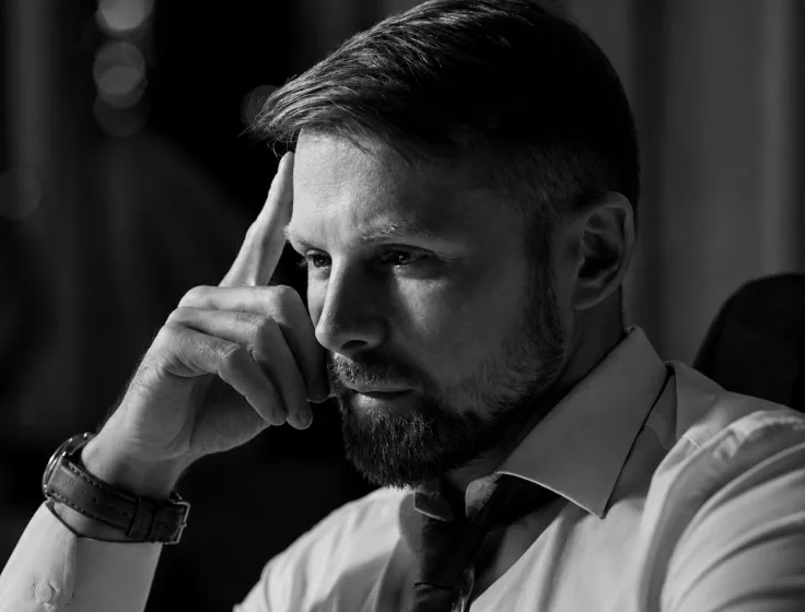 A thoughtful man sitting at a desk