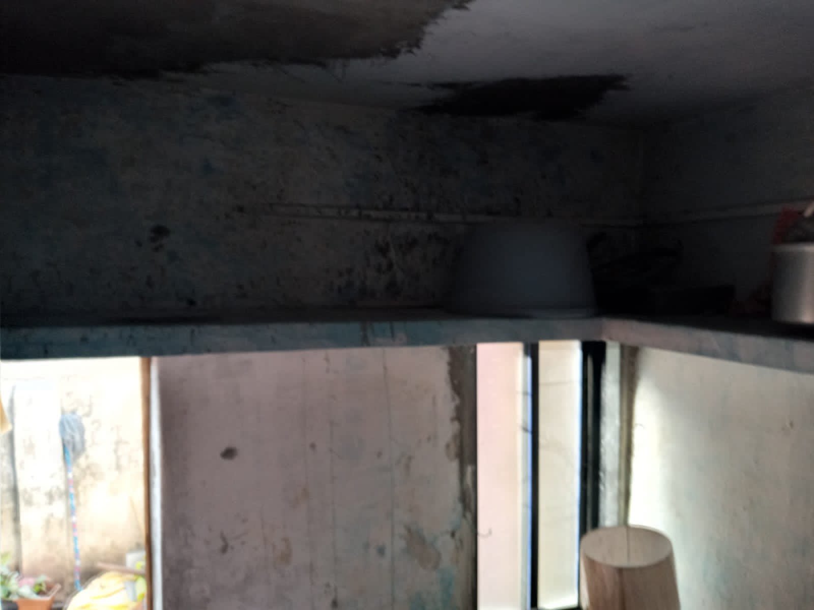 Dark, stained ceiling above a doorway