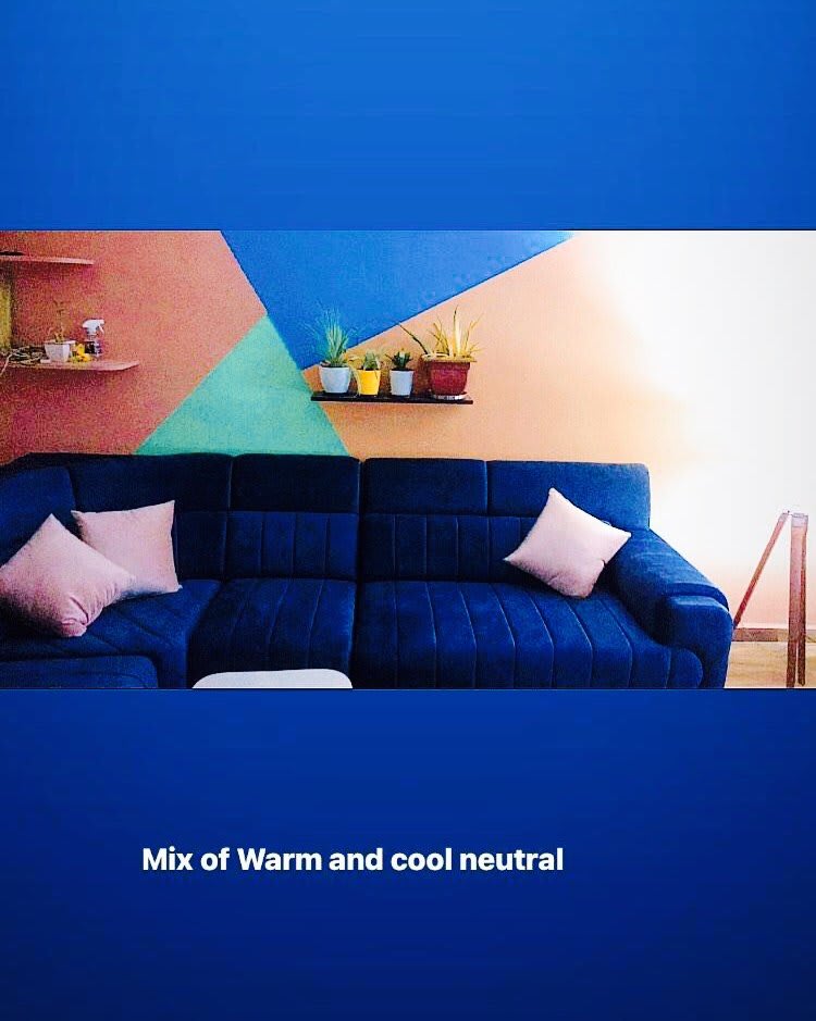 Concept board showing a blue sofa against warm and cool geometric wall colours