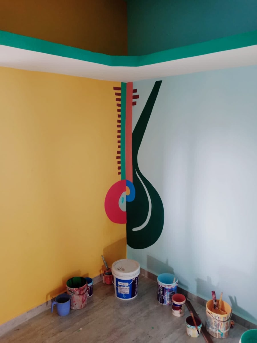 Corner mural of a stylised string instrument across yellow and white walls