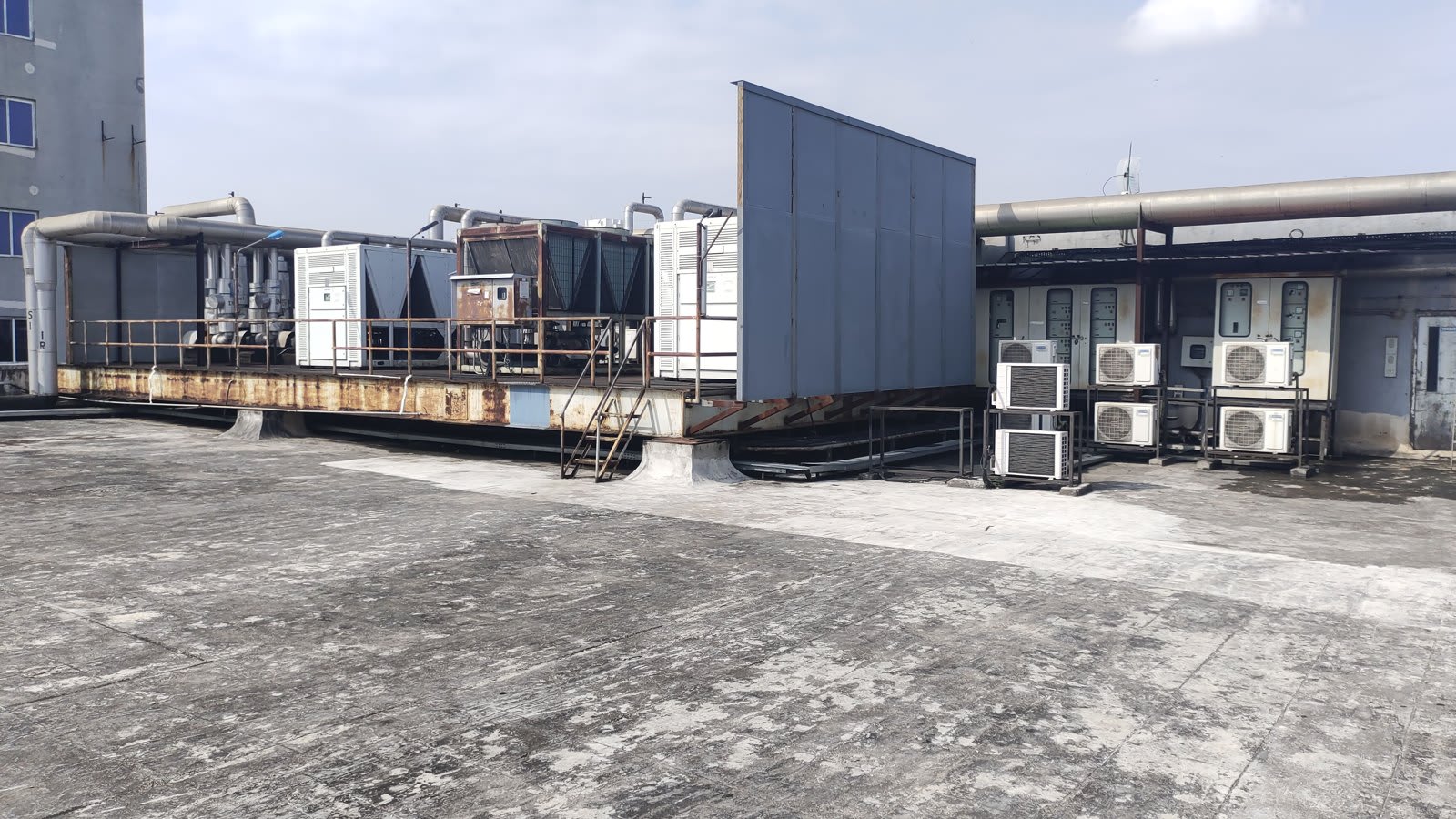 Rooftop with chillers, insulated pipework and split air-conditioning units
