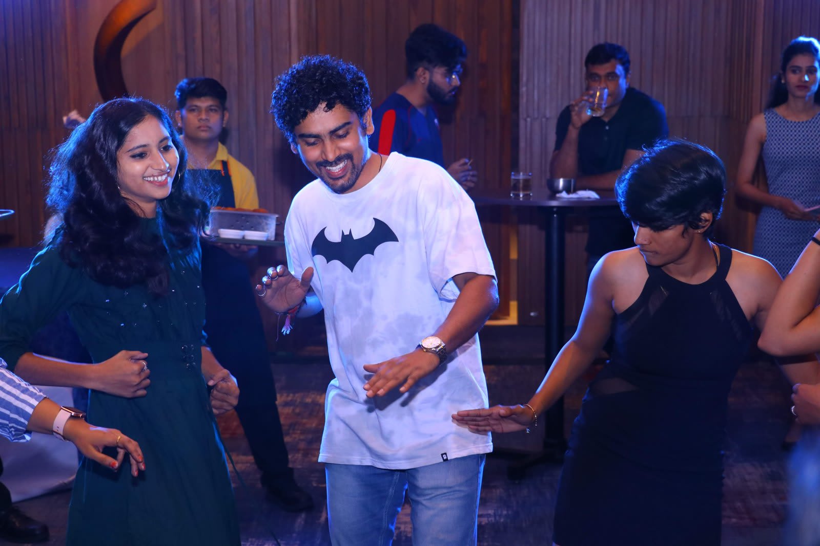 Sagar dancing and laughing with colleagues at a team party