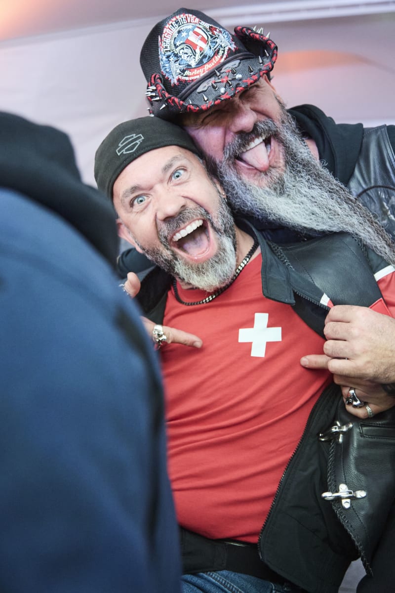 Two men celebrate joyfully in the Glemmtalerhof atmosphere.