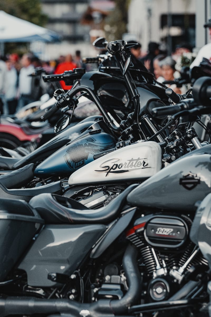 Motorcycles lined up with people in the background in Hinterglemm.