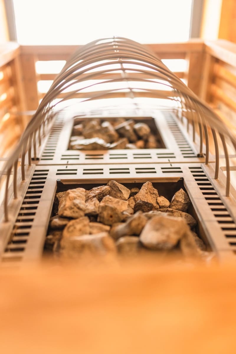 A view of the cozy fireplace in Glemmtalerhof in Hinterglemm with stones.