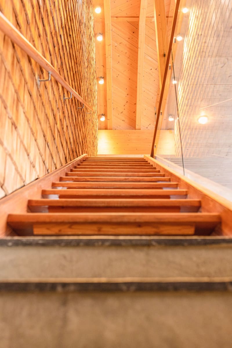 Wooden staircase with warm light in the Glemmtalerhof in Hinterglemm.