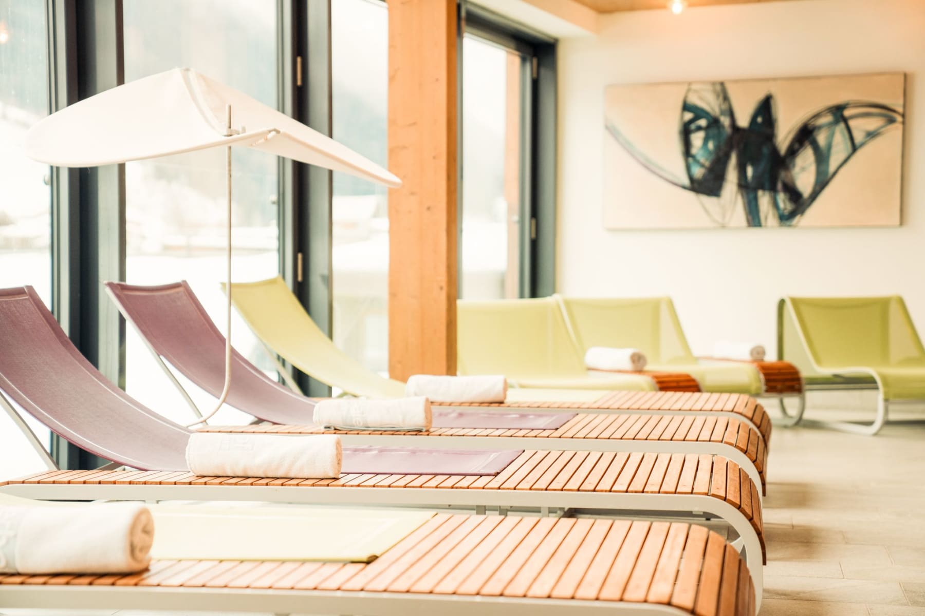 The relaxing wellness area at Glemmtalerhof features modern loungers and plenty of light.