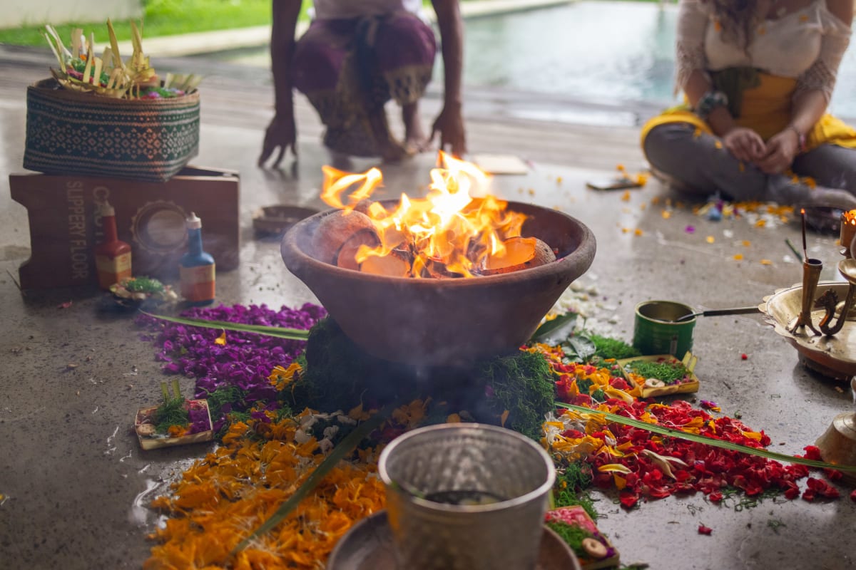 Participants gathered around the fire during a grief workshop in Bali