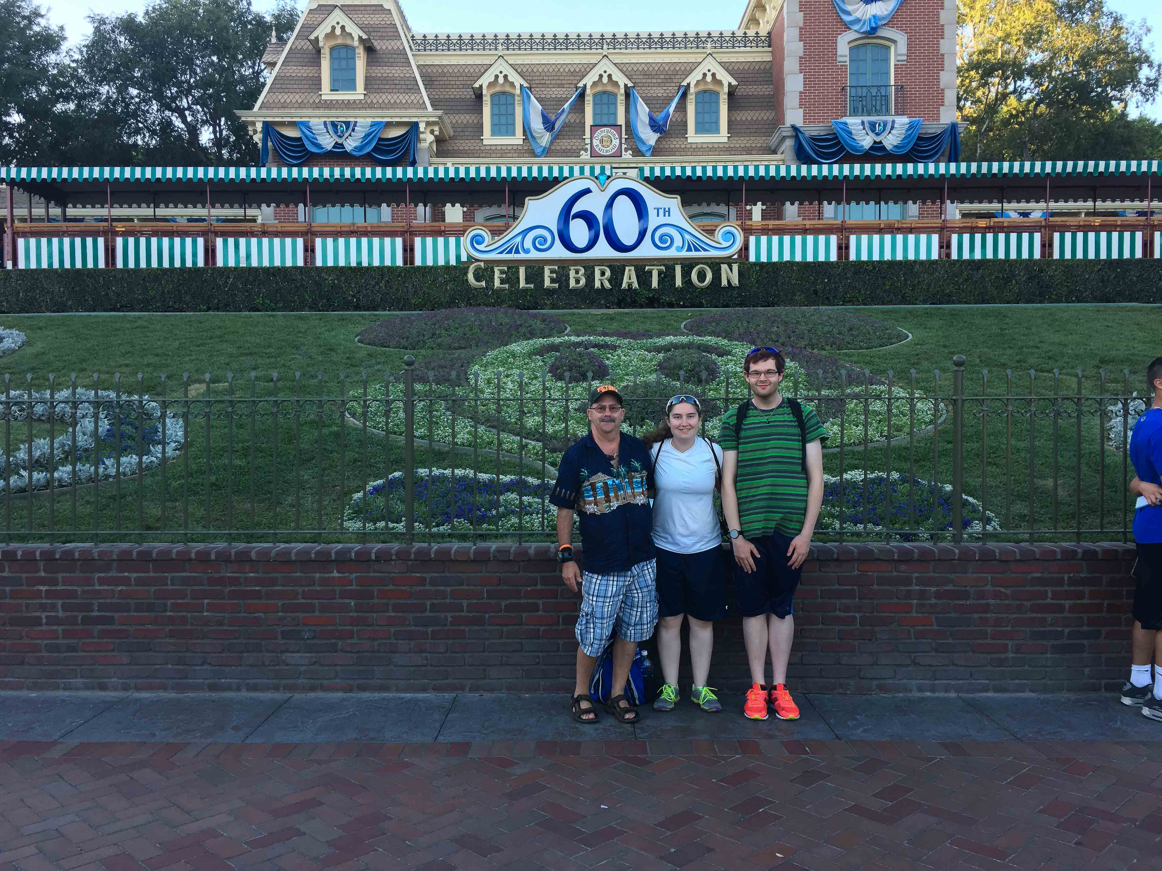 Greg, Brittany, and Donald in-front of the Disneyland entrance