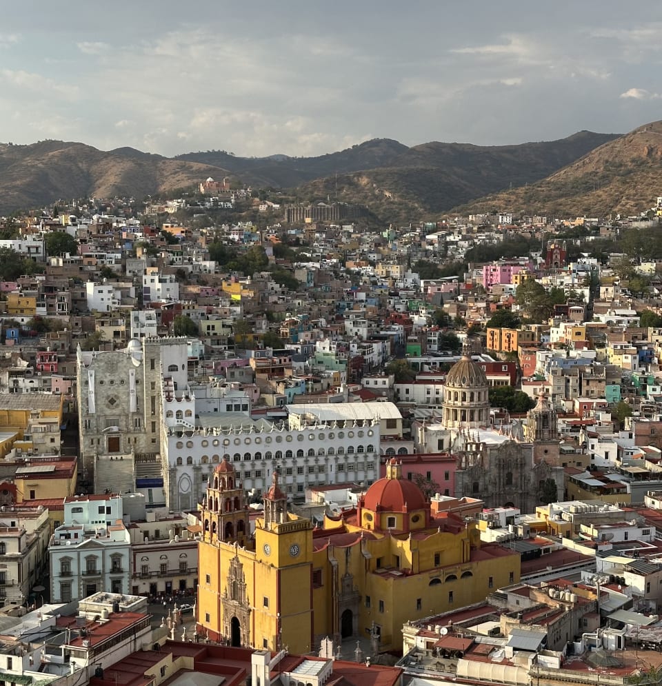 Guanajuato from above: colorful valley city with the basilica and university against surrounding hills