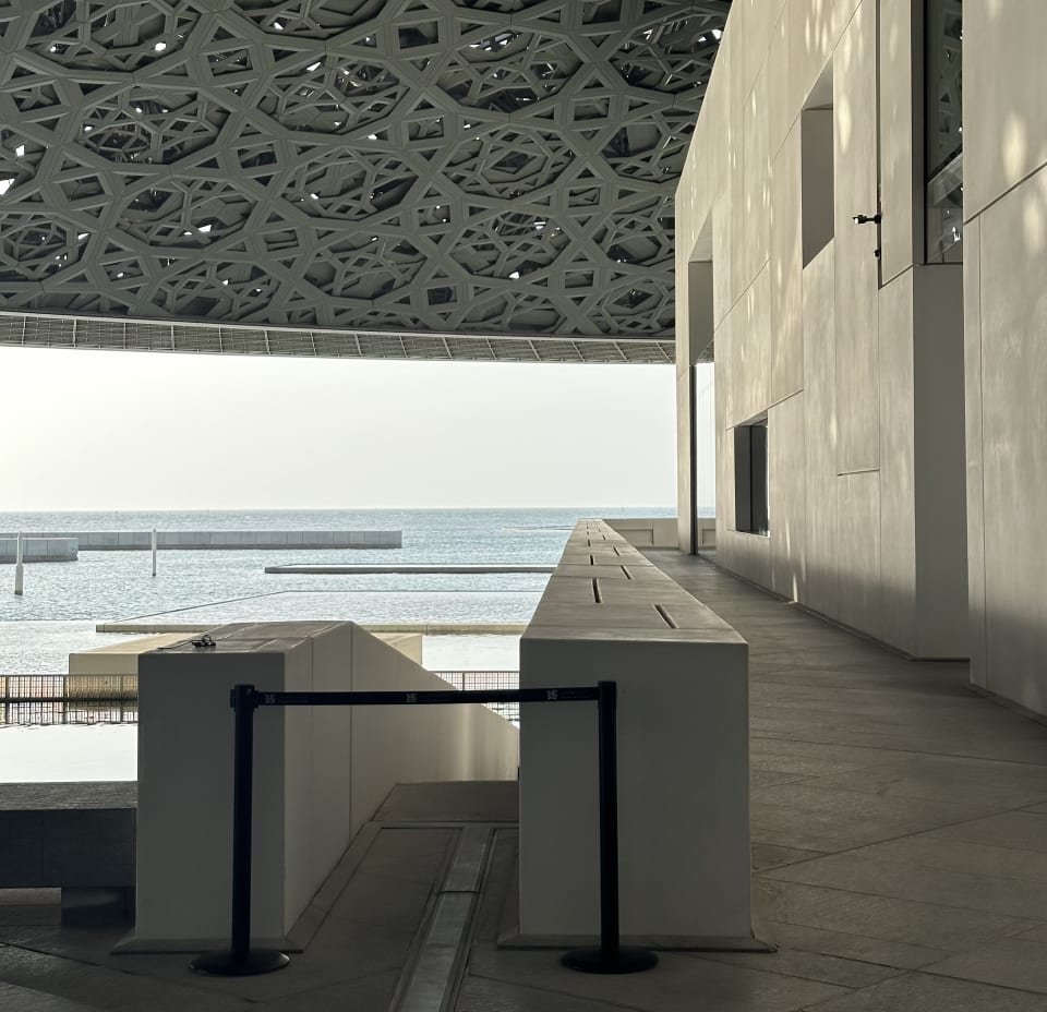 Louvre Abu Dhabi: white galleries and the geometric dome framing the sea