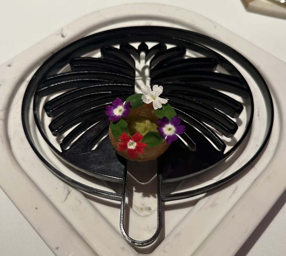 Pani puri–style bite on a black fan-shaped plate at Tresind Studio, Dubai