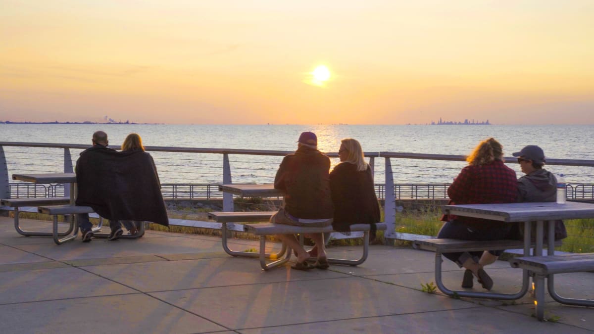 People relaxing by the water at sunset near Portage, Indiana