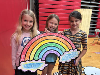 Parade photo of kids with a giant Doodle character