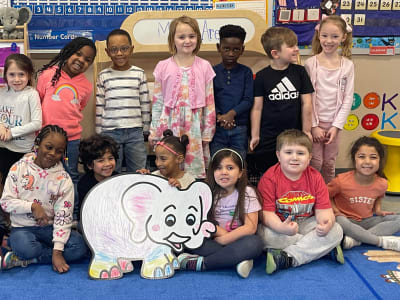 Parade photo of kids with a giant Doodle character