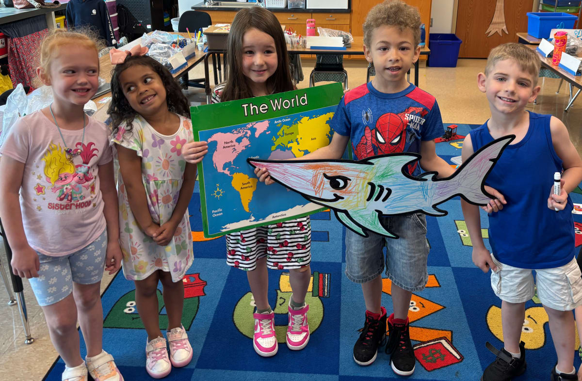 Parade photo of kids with a giant Doodle character