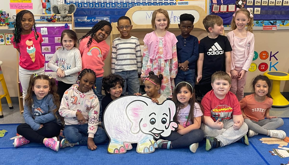 Parade photo of kids with a giant Doodle character