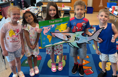 Parade photo of kids with a giant Doodle character
