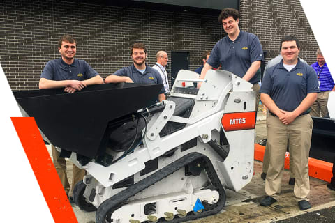 Interns In The Engineering Prototype Program Stand Side-By-Side Around A Bobcat MT85