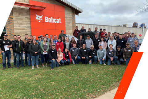 Group Photo Of Students Posing In Front Of The Bobcat Gwinner Factory Following Their Tour