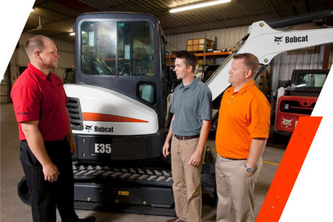 Group Photo around an E35 Compact Excavator