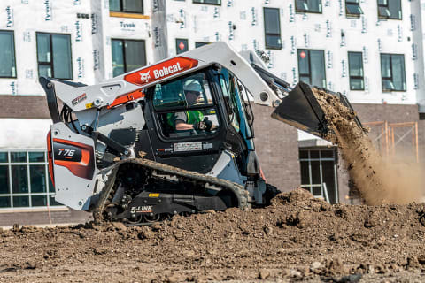 Bobcat Compact Track Loader Hauling Dirt On Apartment Construction Jobsite