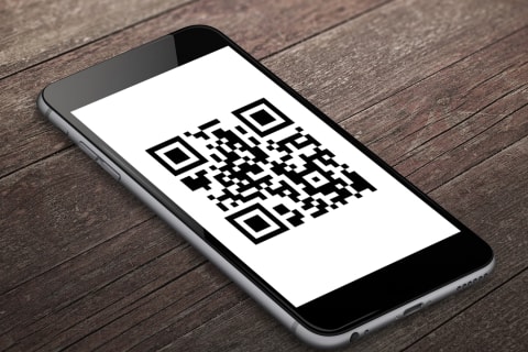 Smartphone with Quick Response (QR) Code for a Bobcat Training Video on the Screen