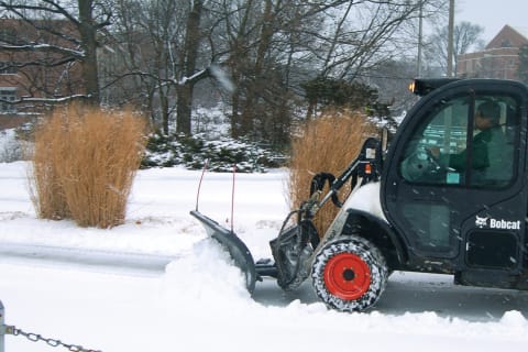 Toolcat Utility Work Machine With Snow Blade Attachment Clearing Snow Off Road