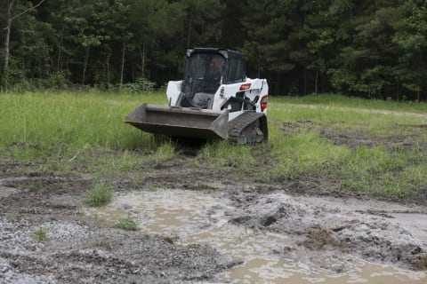 Bobcat T550 Compact Track Loader Navigating Muddy Terrain