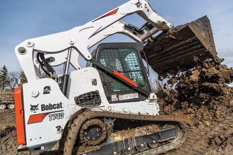  Bobcat T740 compact track loader dumping dirt.